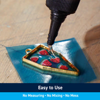 Clear UV Epoxy and a UV flashlight in a kit for filling holes, art pieces, woodworking, and epoxy projects.