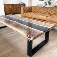 Modern living room with a wooden coffee table and brown leather sofa.