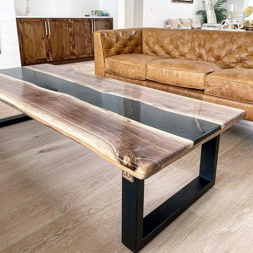 Modern living room with a wooden coffee table and brown leather sofa.